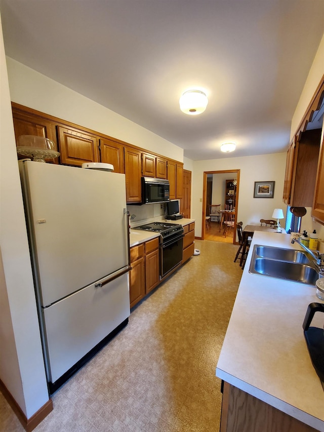 381 Cross Ave Unit 9, 10, Saint Johnsbury, VT 05819 - kitchen featuring black appliances, light countertops, and brown cabinets