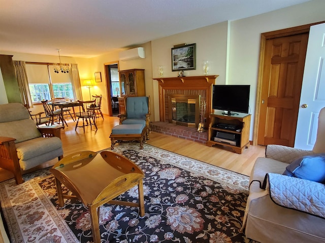 381 Cross Ave Unit 9, 10, Saint Johnsbury, VT 05819 - living area featuring an AC wall unit, wood finished floors, and a brick fireplace