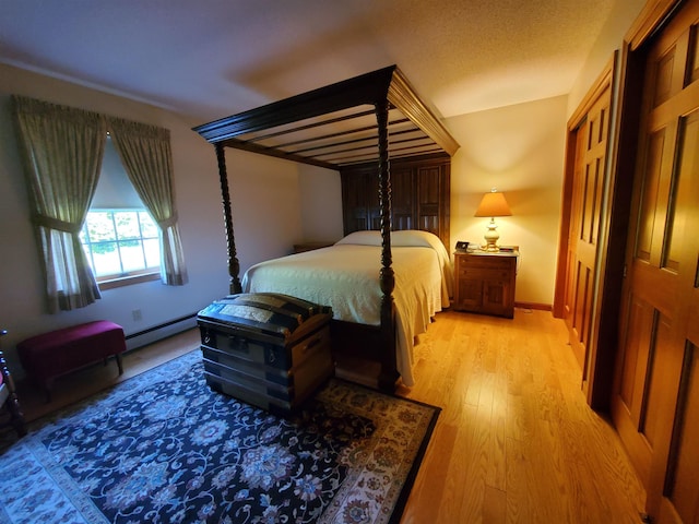 381 Cross Ave Unit 9, 10, Saint Johnsbury, VT 05819 - bedroom featuring light wood-style flooring and a baseboard radiator