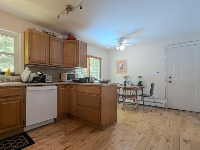 1 Wyeth Farm Cir, Lebanon, NH 03784 - kitchen with white appliances, a baseboard radiator, a peninsula, decorative backsplash, and light wood-type flooring