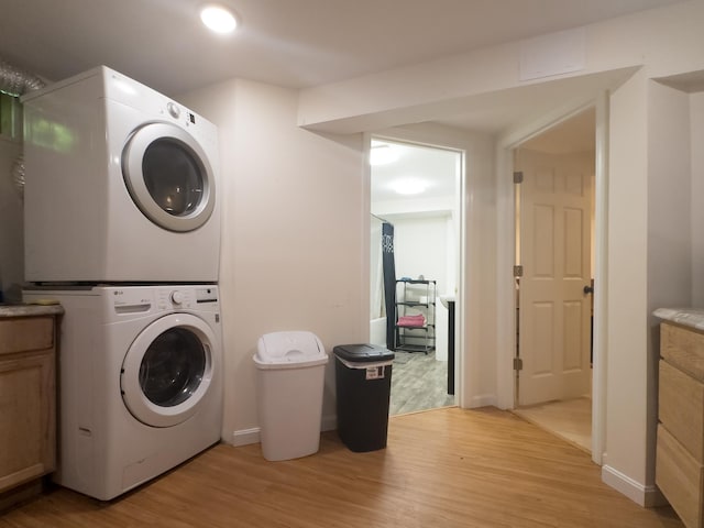 1 Wyeth Farm Cir, Lebanon, NH 03784 - laundry area featuring estacked washer and dryer, light wood-style flooring, cabinet space, and recessed lighting