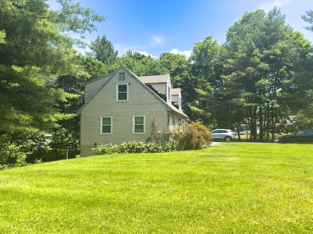 1 Wyeth Farm Cir, Lebanon, NH 03784 - view of side of property featuring a lawn and view of wooded area