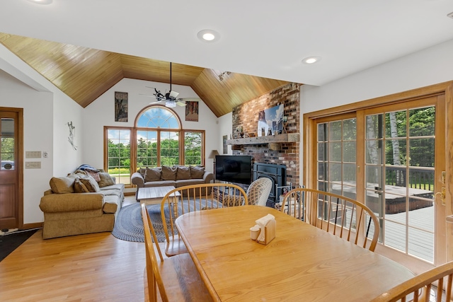 490 W Hill Rd, Ludlow, VT 05149 - dining area featuring a ceiling fan, light wood-style floors, a brick fireplace, vaulted ceiling, and wood ceiling