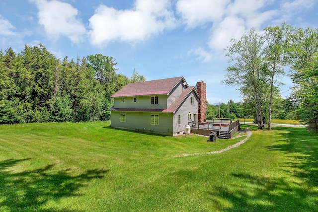490 W Hill Rd, Ludlow, VT 05149 - view of property exterior with a chimney, a wooden deck, and a lawn
