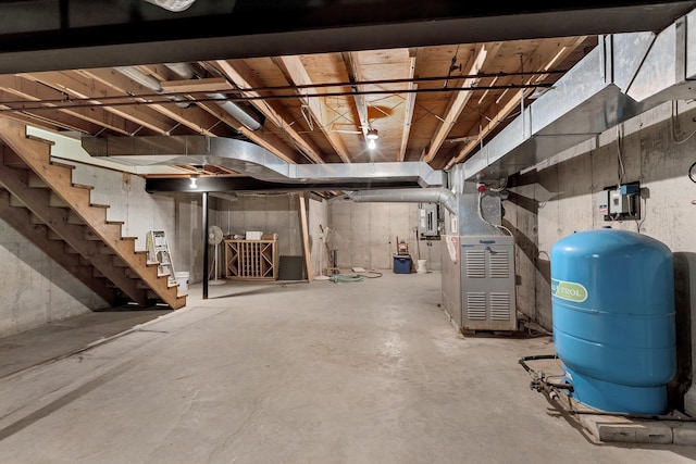 490 W Hill Rd, Ludlow, VT 05149 - unfinished below grade area featuring a water pressure tank, electric panel, heating unit, and stairway