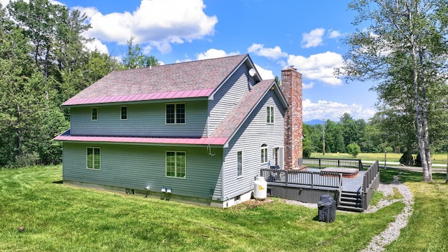 490 W Hill Rd, Ludlow, VT 05149 - rear view of house featuring a lawn, a chimney, a wooden deck, and a metal roof