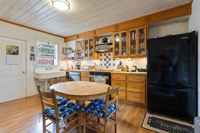 74 Cass St, Portsmouth, NH 03801 - kitchen with freestanding refrigerator, stainless steel dishwasher, open shelves, brown cabinets, and light countertops