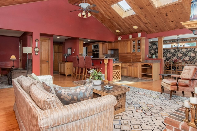 3 Mooreland Ave, Concord, NH 03301 - living area with high vaulted ceiling, ceiling fan, light wood-type flooring, a skylight, and a chandelier