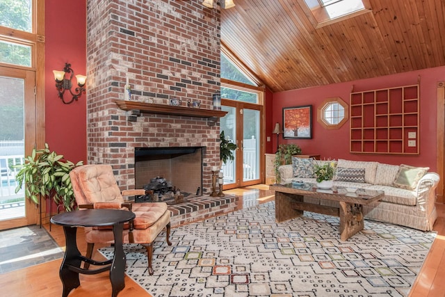3 Mooreland Ave, Concord, NH 03301 - living area featuring wood finished floors, a fireplace, high vaulted ceiling, wood ceiling, and a skylight