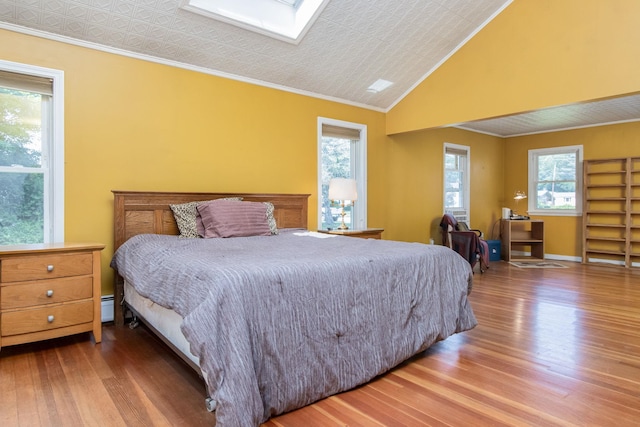3 Mooreland Ave, Concord, NH 03301 - bedroom featuring wood finished floors, ornamental molding, a skylight, and baseboard heating