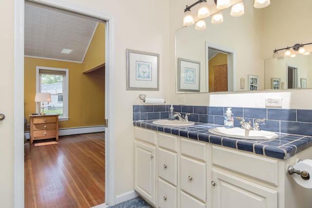 3 Mooreland Ave, Concord, NH 03301 - full bathroom with a baseboard heating unit, ornamental molding, double vanity, and wood finished floors