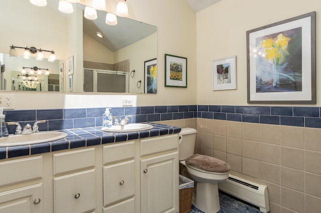 3 Mooreland Ave, Concord, NH 03301 - full bathroom with a baseboard radiator, a shower stall, double vanity, lofted ceiling, and tile walls