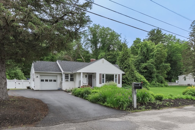 3 Mooreland Ave, Concord, NH 03301 - view of front of property with an attached garage, asphalt driveway, a chimney, and a shingled roof
