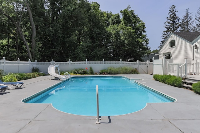 3 Mooreland Ave, Concord, NH 03301 - view of swimming pool with a water slide, a patio, a fenced backyard, a gate, and a deck
