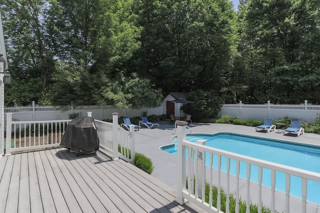 3 Mooreland Ave, Concord, NH 03301 - view of swimming pool featuring a storage shed, a fenced backyard, a wooden deck, a patio area, and area for grilling