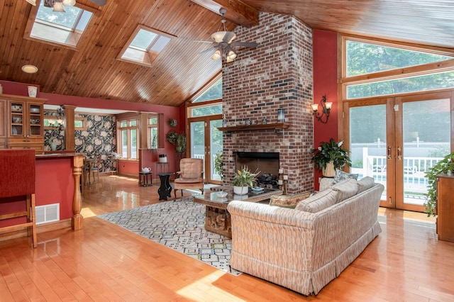 3 Mooreland Ave, Concord, NH 03301 - living room featuring french doors, wood-type flooring, high vaulted ceiling, a fireplace, and a ceiling fan