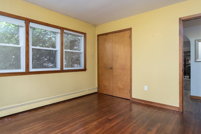 3 Mooreland Ave, Concord, NH 03301 - unfurnished bedroom featuring a baseboard heating unit, dark wood-style floors, and a closet