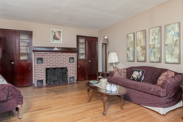 3 Mooreland Ave, Concord, NH 03301 - living room featuring wood finished floors, arched walkways, and a brick fireplace