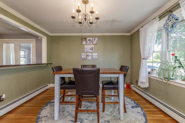 6 Hobart St, Concord, NH 03303 - dining area with a baseboard heating unit, a chandelier, wood finished floors, and ornamental molding