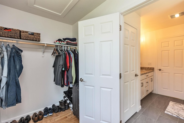 116 Sullivan Center Rd, Gilsum, NH 03448 - spacious closet featuring attic access and dark tile patterned floors