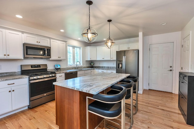 116 Sullivan Center Rd, Gilsum, NH 03448 - kitchen with stainless steel appliances, light wood-style flooring, a breakfast bar area, white cabinets, and recessed lighting