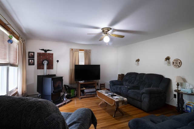 1061 Suncook Valley Rd, Barnstead, NH 03225 - living area featuring a wood stove, a ceiling fan, and wood finished floors