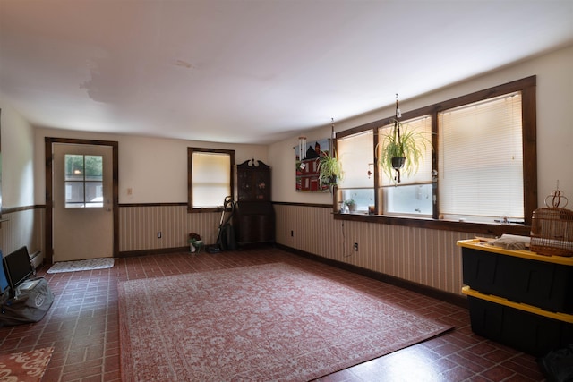 1061 Suncook Valley Rd, Barnstead, NH 03225 - unfurnished living room featuring wainscoting and baseboards