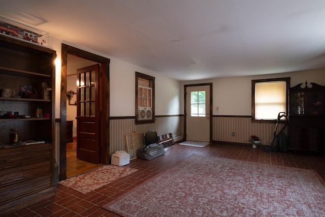 1061 Suncook Valley Rd, Barnstead, NH 03225 - living area with a wainscoted wall and brick patterned flooring