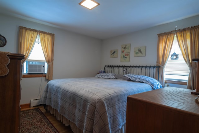 1061 Suncook Valley Rd, Barnstead, NH 03225 - bedroom featuring cooling unit, baseboard heating, multiple windows, and wood finished floors