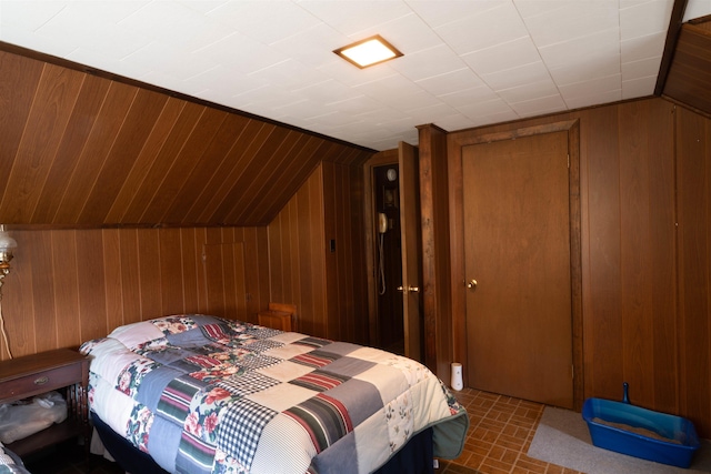 1061 Suncook Valley Rd, Barnstead, NH 03225 - bedroom featuring wooden walls, vaulted ceiling, a closet, and brick patterned flooring