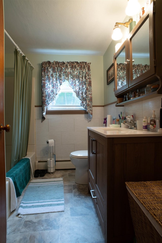 1061 Suncook Valley Rd, Barnstead, NH 03225 - full bathroom with tile walls, vanity, a wainscoted wall, baseboard heating, and shower / bath combo