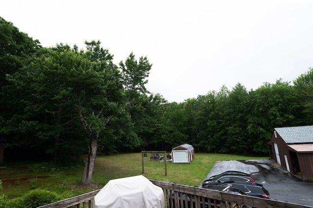 1061 Suncook Valley Rd, Barnstead, NH 03225 - view of grassy yard with an outdoor structure and a forest view