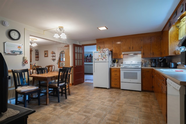 1061 Suncook Valley Rd, Barnstead, NH 03225 - kitchen with white appliances, brown cabinetry, under cabinet range hood, light countertops, and tasteful backsplash