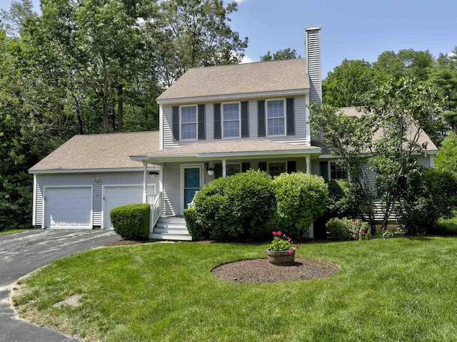 8 Sycamore Ct, Amherst, NH 03031 - view of front facade featuring driveway, a garage, a chimney, and a front lawn