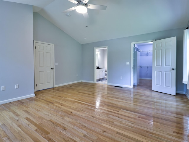 8 Sycamore Ct, Amherst, NH 03031 - unfurnished bedroom featuring light wood-style flooring, connected bathroom, a walk in closet, a ceiling fan, and high vaulted ceiling