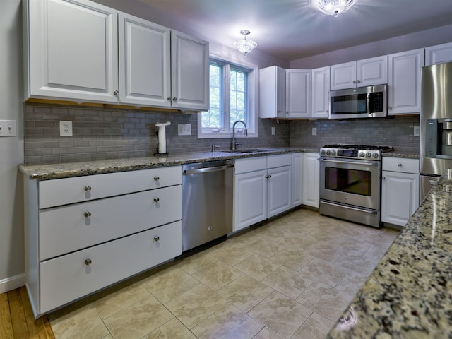 8 Sycamore Ct, Amherst, NH 03031 - kitchen with appliances with stainless steel finishes, light stone counters, white cabinetry, and tasteful backsplash