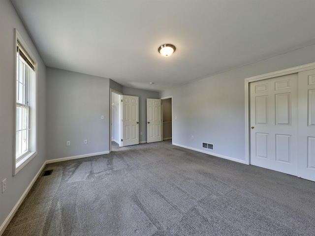 8 Sycamore Ct, Amherst, NH 03031 - unfurnished bedroom with dark carpet and baseboards