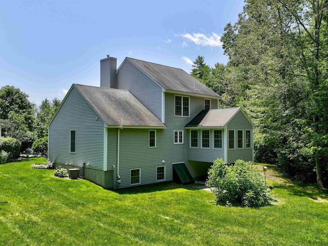 8 Sycamore Ct, Amherst, NH 03031 - rear view of property with a lawn, a chimney, and roof with shingles