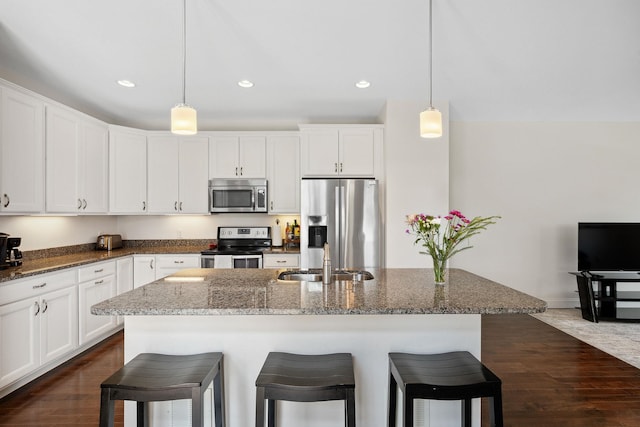 394 Zephyr Rd, Williston, VT 05495 - kitchen with stainless steel appliances, recessed lighting, dark wood finished floors, a breakfast bar area, and white cabinets