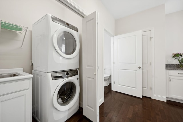 394 Zephyr Rd, Williston, VT 05495 - washroom with stacked washer / drying machine and dark wood finished floors