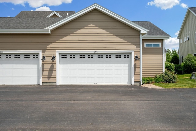 394 Zephyr Rd, Williston, VT 05495 - view of front of home with a shingled roof, a garage, and asphalt driveway