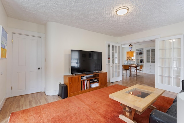 19 Baker St, Dover, NH 03820 - living room featuring french doors, wood finished floors, a desk, and an ornate ceiling
