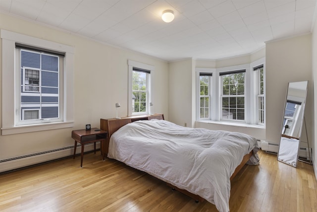 19 Baker St, Dover, NH 03820 - bedroom featuring crown molding, wood-type flooring, and a baseboard heating unit