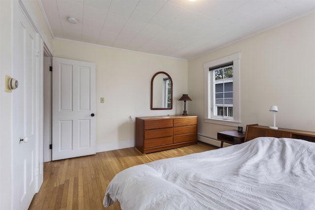 19 Baker St, Dover, NH 03820 - bedroom featuring a baseboard radiator, crown molding, and light wood-style flooring