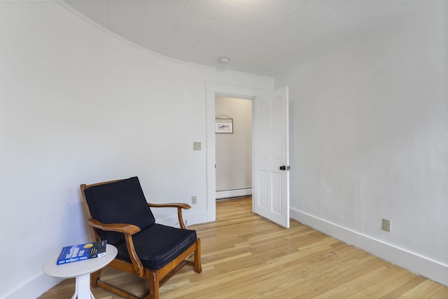 19 Baker St, Dover, NH 03820 - sitting room featuring baseboard heating and light wood finished floors