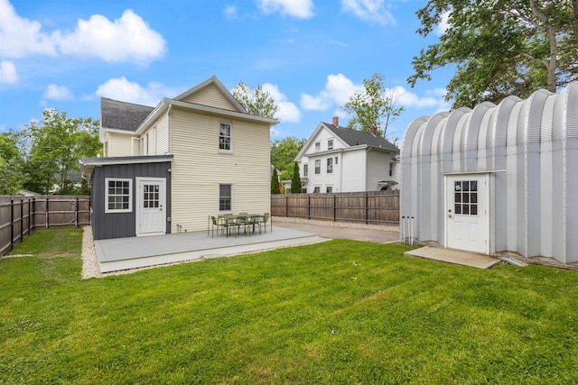 19 Baker St, Dover, NH 03820 - back of property featuring a patio, a fenced backyard, board and batten siding, and an outdoor structure
