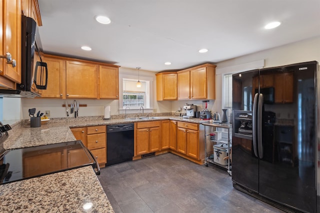 19 Baker St, Dover, NH 03820 - kitchen featuring black appliances, light stone counters, recessed lighting, pendant lighting, and brown cabinetry