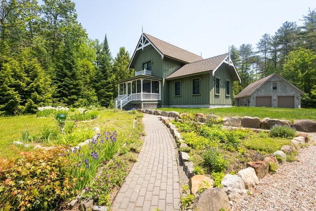 185 Huntress Bridge Rd, Effingham, NH 03882 - view of front of house featuring a garage, board and batten siding, an outbuilding, and a shingled roof
