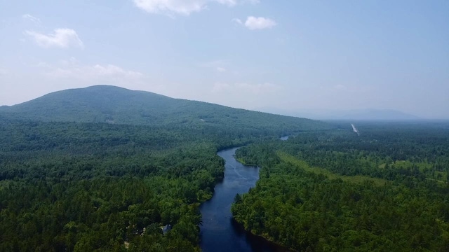 185 Huntress Bridge Rd, Effingham, NH 03882 - view of mountain backdrop with a heavily wooded area and a large body of water