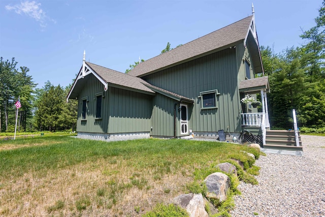 185 Huntress Bridge Rd, Effingham, NH 03882 - view of property exterior with roof with shingles, board and batten siding, and a yard